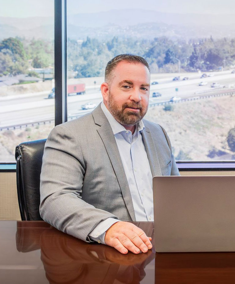 Photo of Jim and Noah sitting at a table in a conference room.